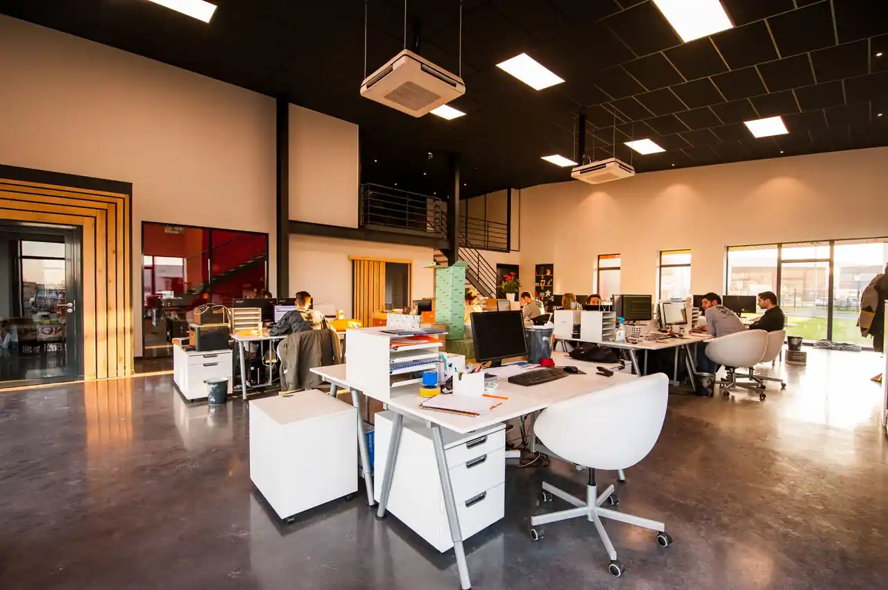 Modern agency studio with strategic workflow stations and quiet collaborative areas