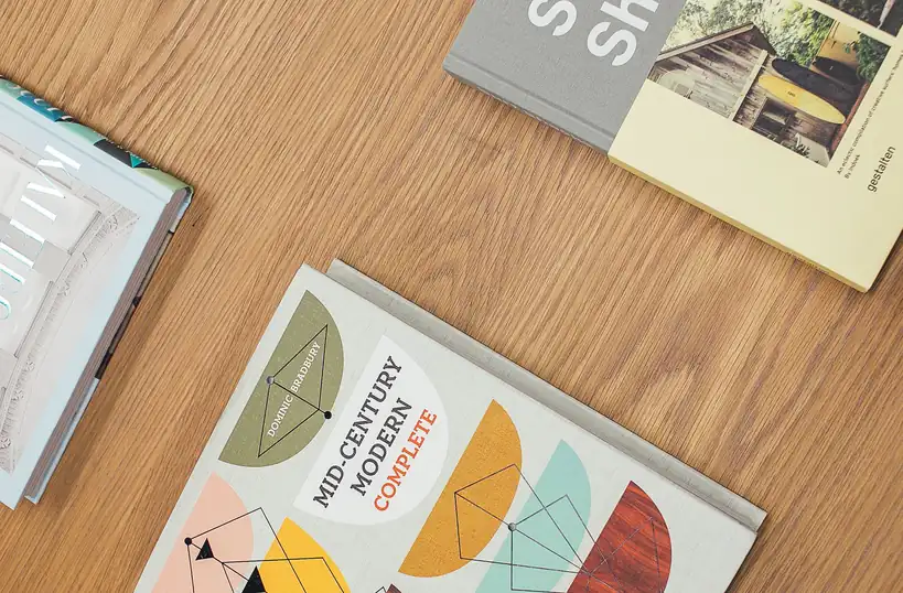 Collection of architectural monographs on studio desk