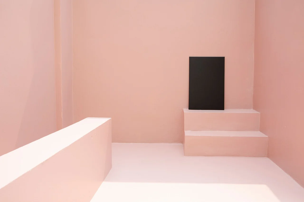 Monochrome canvas in gallery staircase setting illustrating spatial scale